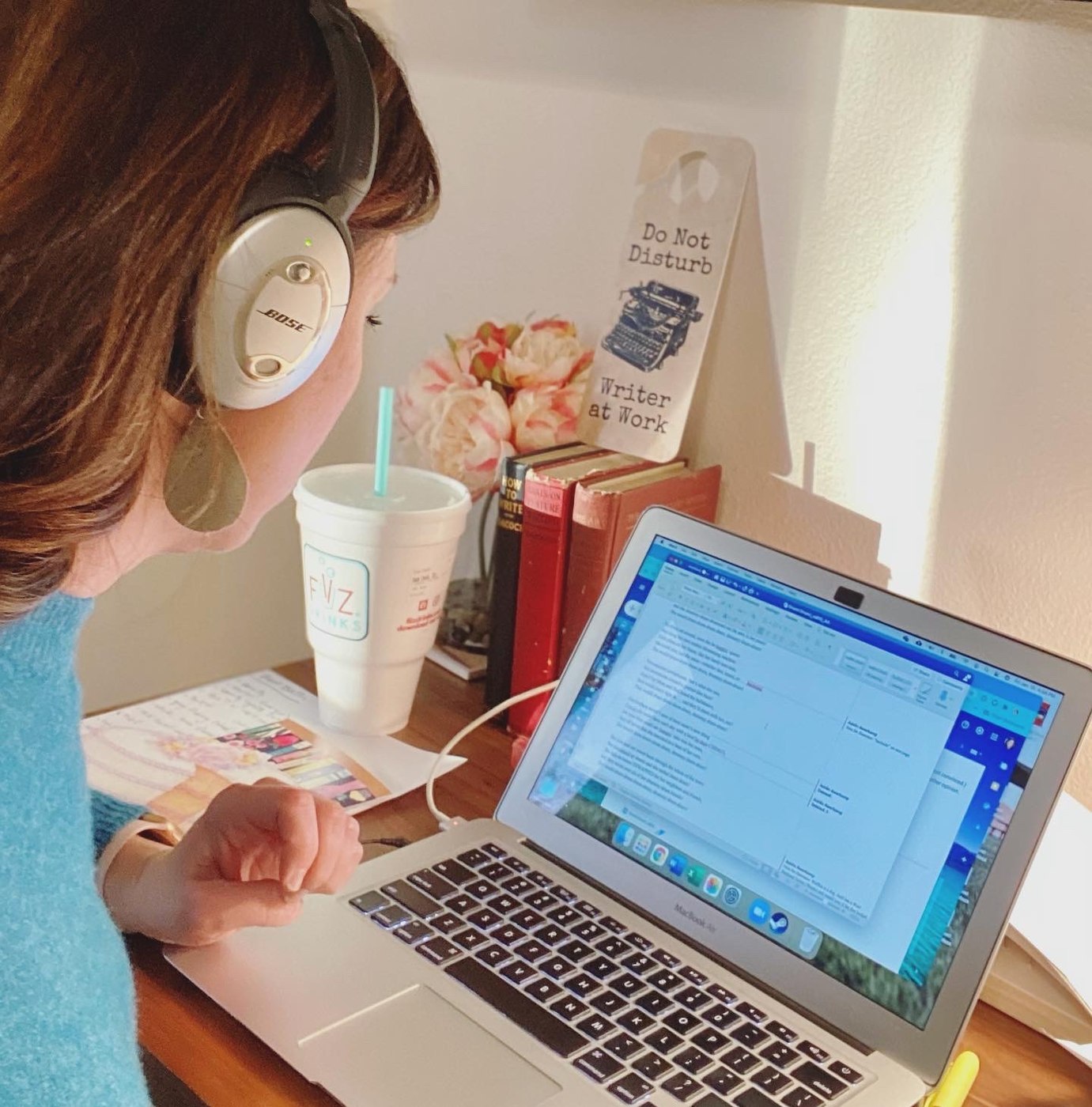 Andi Kate at her desk, editing